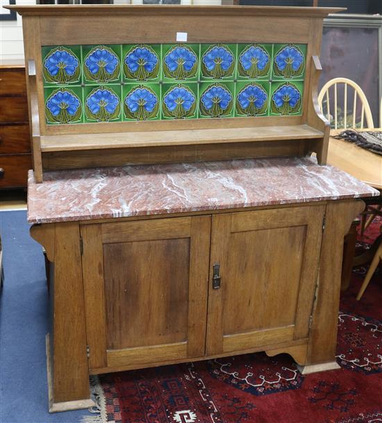 A late 19th century mahogany Aesthetic movement mahogany marble topped washstand with tiled back, H.140cm W.131cm W.131cm